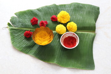 Traditional Hindu Pooja Essential items, Bannana leaf,Turmeric, Kumkum, Mari gold flower Isolated on White Background