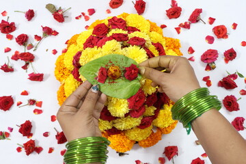 colorful flowers stacked up to create bathukamma, a specific hindu god worshiped in south india