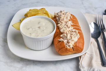 tuna salad sub with clam chowder,  and a side of chi=s.