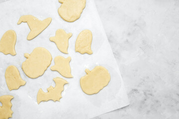 Making different shapes of fall cookies for Halloween. Dough with cookie cutter