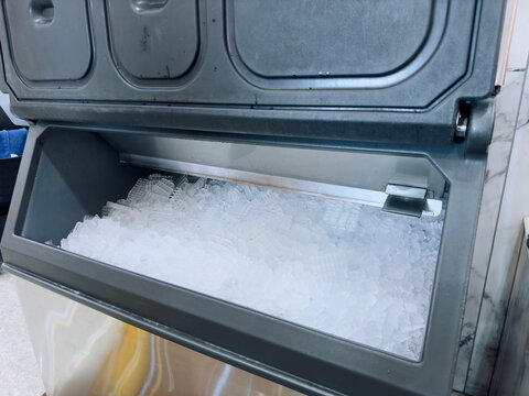 Ice cubes store in ice making machine for clean product. Ice cube maker. Cube ice machine. Suitable for small beverage shops.