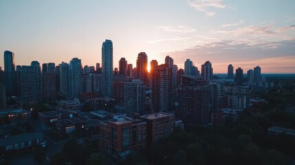 Fototapeta premium Aerial view of a city skyline at sunset with high-rise buildings, leaving space for copy in the sky.