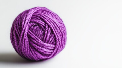 Close up of a purple yarn ball on a white background ideal for craft and knitting themes