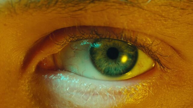Detailed blue eye with strong gaze, showing human anatomy and beauty, thriller depression halloween style. Drugs concept.