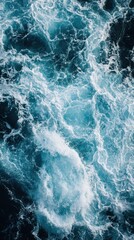 Fototapeta premium Stunning aerial view of powerful ocean waves in a turbulent sea, featuring diverse shades of blue and white foam. ideal for nature-inspired design, print, or poster.