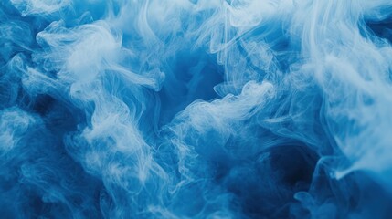 Obraz premium Beautiful swirling blue smoke creating an ethereal and calming abstract background.