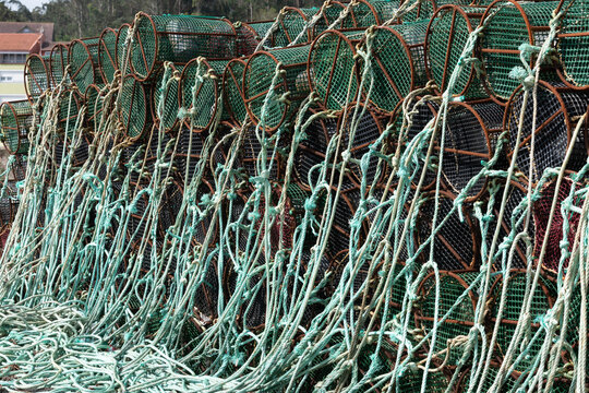 Stacked fishing pots and tangled ropes on the dock