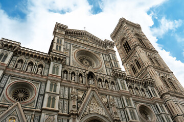 Fototapeta premium Florence Cathedral facade - Duomo di Firenze. Beautiful religious building with cloudy sky