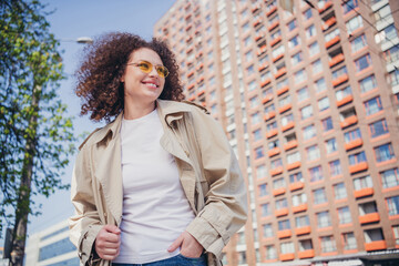 Photo of pretty adorable girl dressed stylish trench walking in the downtown megapolis sunny weather outdoors