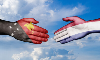 Netherlands and Papua New Guinea country handshaking with flags, consensus concept international...