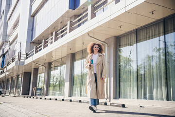 Obraz premium Photo of lovely adorable girl dressed stylish beige clothes walking downtown big city spring sunny weather outdoors