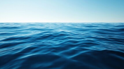 Fototapeta premium Serene ocean view with calm waves beneath a clear blue sky, perfect for relaxation and tranquility themes.