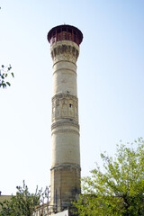 Historical architecture of Gaziantep, Türkiye: the minaret tower of the Eyüpoğlu Mosque, located in the Şahinbey district, decorated with traditional carvings and topped with a balcony for the muezzin