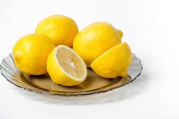 Three lemons in a basket on a white background