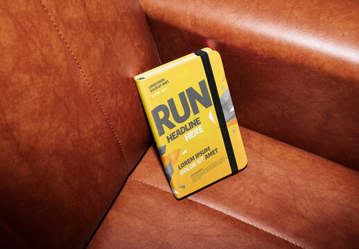 Notebook on Leather Couch. Customizable PSD mockup