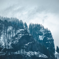 moody snowy mountain cliffside landscape