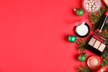 Flat lay composition with makeup products and Christmas decor on red background, space for text