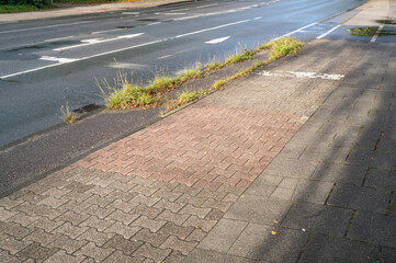 wet road with cycle path and sidewalk, poorly maintained