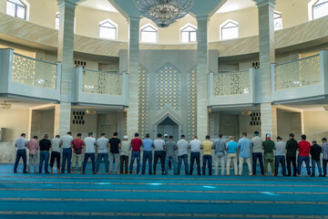 The group of Muslim men praying in Grand mosque of Maykop, Adygea Republic at North Caucasus, Russia.
