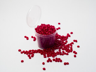 Red masterbatch granules isolated on white background, color pigment carrier polymer in plastics...