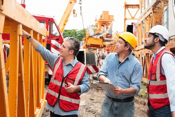 Team of workers at construction site with heavy machines.