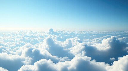 Aerial perspective showcasing a vast spread of fluffy white clouds beneath a clear blue sky highlighting the serene beauty of high altitude views