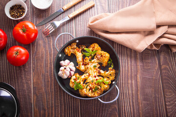 Cauliflower steak with spices and herbs cooked in the oven. Healthy vegan organic cuisine.