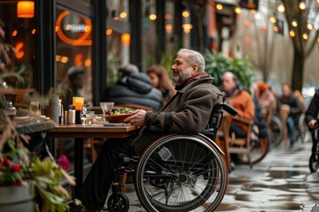 Obraz premium A man in a wheelchair sits at a table with a salad in front of him