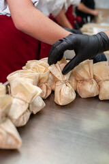Close shot for preparing filo pastry pouches in restaurant kitchen, no face