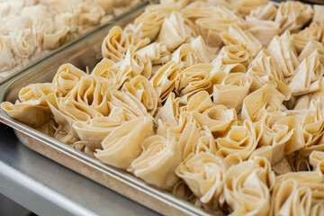 Close shot for preparing filo pastry pouches in restaurant kitchen, no face