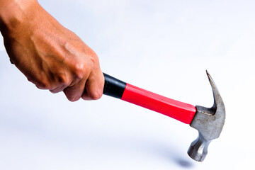 Man hand holding a hammer with a handle covered in black and red rubber Cut Out, isolated on white background. Old rusty hammer. with clipping path