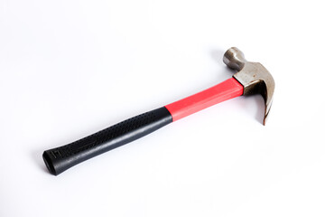 Close up medium sized hammer that has two functions as a nail pick and nail hammer, with a handle covered in black and red rubber isolated on a white background. Little bit rusty