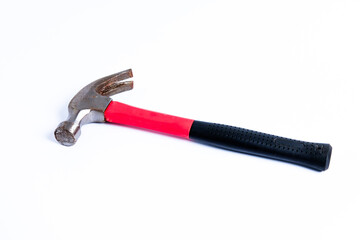 Close up medium sized hammer that has two functions as a nail pick and nail hammer, with a handle covered in black and red rubber isolated on a white background. Little bit rusty