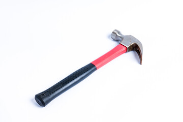 Close up medium sized hammer that has two functions as a nail pick and nail hammer, with a handle covered in black and red rubber isolated on a white background. Little bit rusty