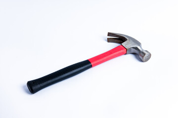 Close up medium sized hammer that has two functions as a nail pick and nail hammer, with a handle covered in black and red rubber isolated on a white background. Little bit rusty
