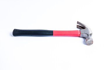 Close up medium sized hammer that has two functions as a nail pick and nail hammer, with a handle covered in black and red rubber isolated on a white background. Little bit rusty