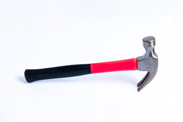 Close up medium sized hammer that has two functions as a nail pick and nail hammer, with a handle covered in black and red rubber isolated on a white background. Little bit rusty