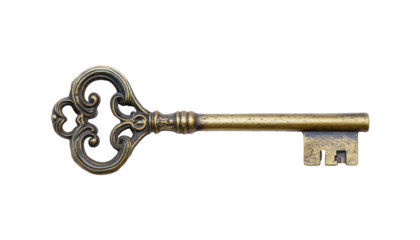 A close-up of an ornate antique brass key with a detailed head and a worn finish.