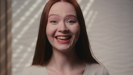 Smiling girl portrait Caucasian ginger happy woman lady in home bathroom talk to camera nod head speak friendly smile toothy laugh female beauty blogger influencer tutorial makeup online blog in bath