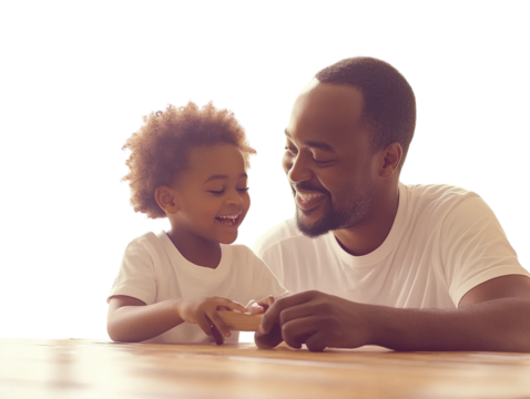 Father and son playing tactile game on wooden table PNG transparent.
