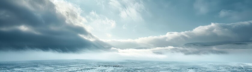 Obraz premium A cloudy sky with a snow covered field