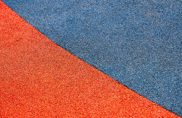 Fototapeta premium A vibrant red and blue rubber surface invites playful exploration and sparks creativity in children.