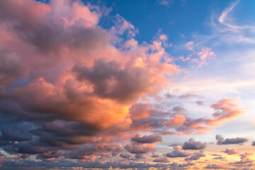 Small clouds in dramatic real sky at sunset texture background overlay.