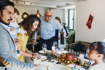 Latin family having Christmas dinner at home in Mexico Latin America, hispanic people eating at...