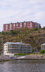Obraz premium Waterfront apartment houses at the pier Finnboda and hill apartment houses on the hill Finnberget, a summer day in Stockholm