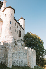 Bobolice Royal Castle at Sunset, Surrounded by dark green Forest and Hills Stunning Medieval Fortress in Poland’s Countryside, Ideal for travel, architecture, and historical content. High quality