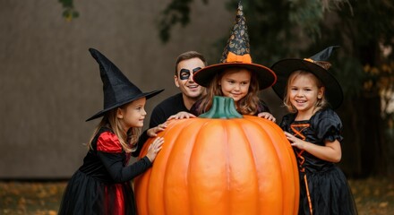 Obraz premium Happy kids in Halloween costumes with a pumpkin