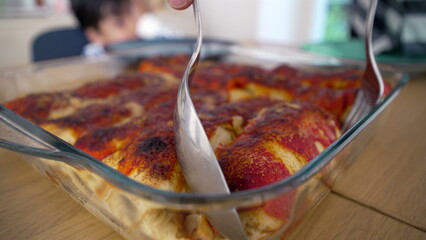 Freshly baked, homemade enchiladas in a glass baking dish on the dining table, ready to be served and enjoyed