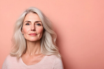Portrait of serene mature woman with gray hair and light background