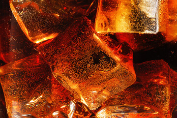 Close up cold drink of Cola with ice cubes. Shallow depth of field